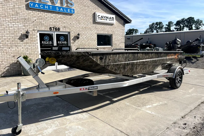 Slide: The Image of 2026 Excel 1754 Shallow Water F4 Pro Hull boat on trailer at dealership. - 1