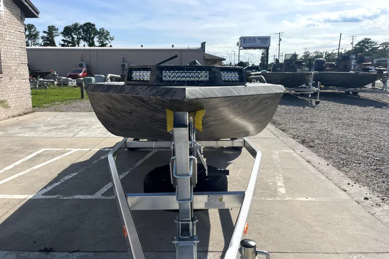 Slide: The Image of 2026 Excel 1754 Shallow Water F4 Pro Hull boat on trailer, outdoor display. - 2