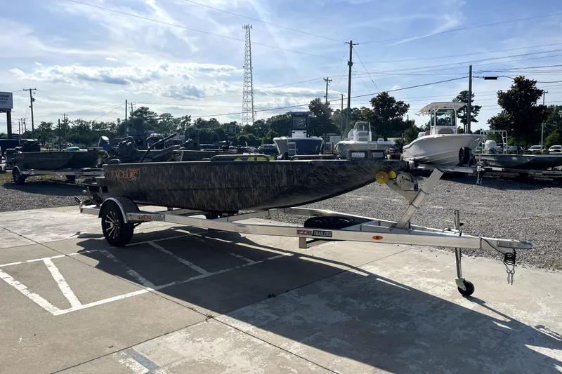 Slide: The Image of 2026 Excel 1754 Shallow Water F4 Pro Hull boat on trailer in parking lot. - 3