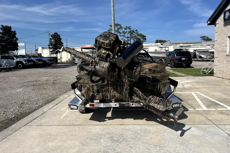 Slide: The Image of 2026 Excel 1754 Shallow Water F4 Pro Hull boat on trailer, camouflaged design. - 5