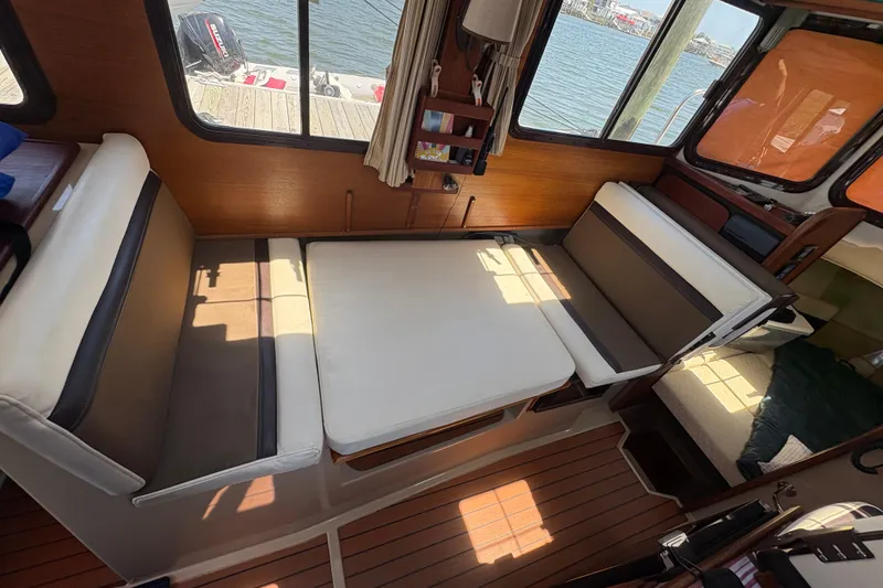 Slide: The Image of Interior of a 2017 Ranger Tugs R-27 with cozy seating and wooden flooring. - 28