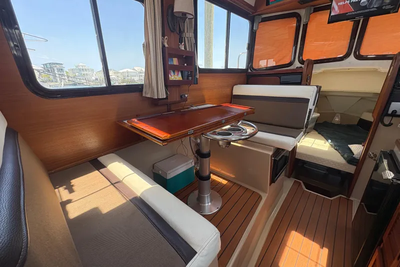 Slide: The Image of Interior of 2017 Ranger Tugs R-27 boat with seating and table. - 15
