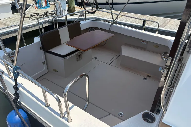 Slide: The Image of 2017 Ranger Tugs R-27 boat cockpit with seating and table, docked at marina. - 28