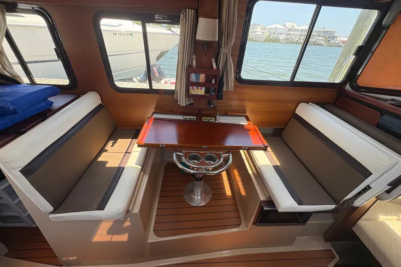 Slide: The Image of Interior of 2017 Ranger Tugs R-27 with dining area and waterfront view. - 17