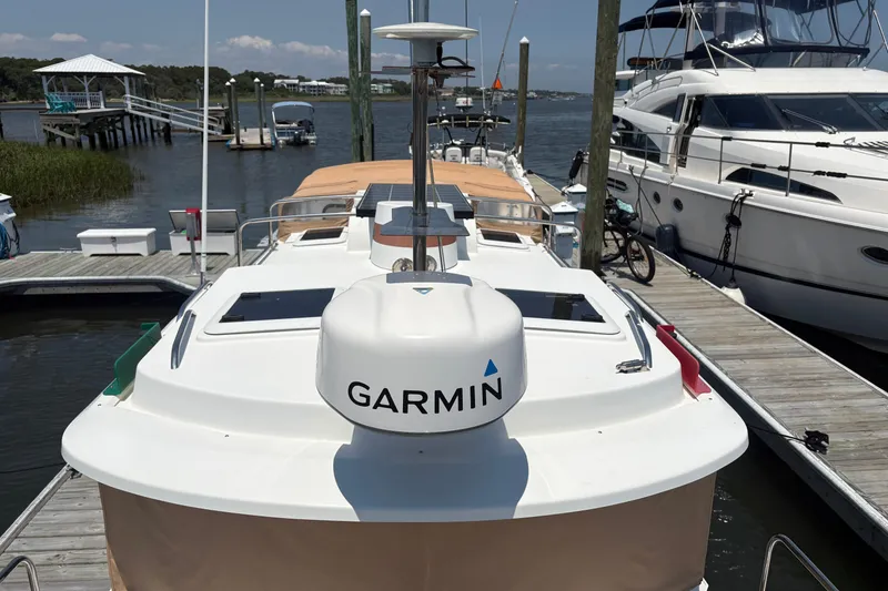 Slide: The Image of 2017 Ranger Tugs R-27 docked with Garmin navigation system, surrounded by other boats. - 14