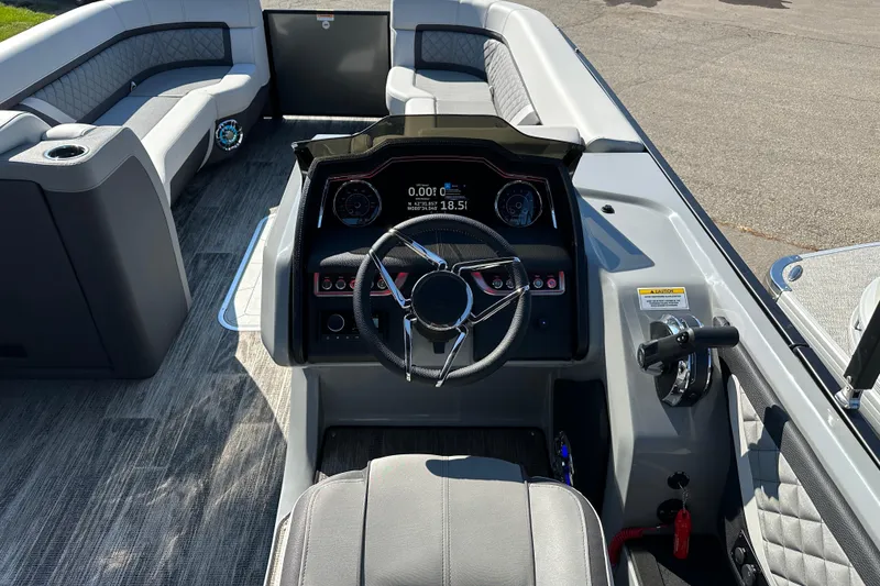 Slide: The Image of 2025 Godfrey AquaPatio 255 SB boat interior with modern steering console and seating. - 15