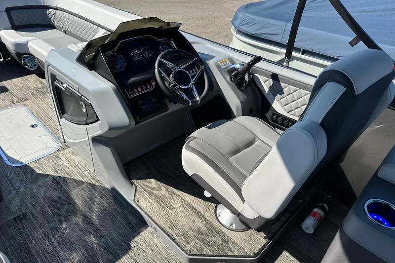 Slide: The Image of 2025 Godfrey AquaPatio 255 SB boat interior with modern helm and seating. - 16