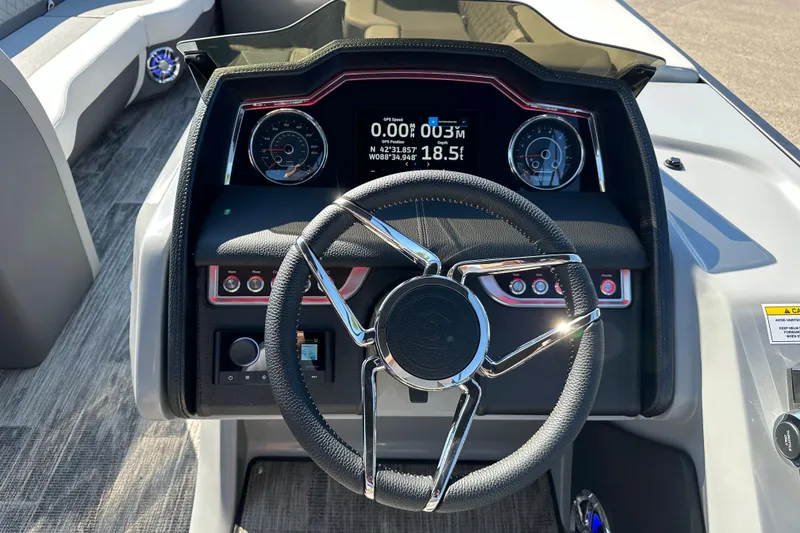 Slide: The Image of Steering console of 2025 Godfrey AquaPatio 255 SB pontoon boat with modern dashboard. - 17