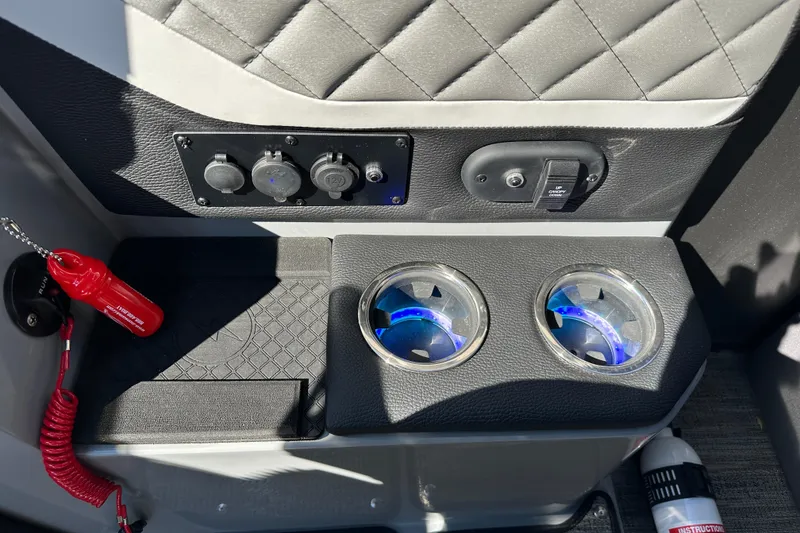 Slide: The Image of Interior of 2025 Godfrey AquaPatio 255 SB with cup holders and control panel. - 18
