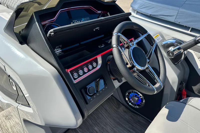Slide: The Image of Steering console of 2025 Godfrey AquaPatio 255 SB boat with modern controls and dashboard. - 23