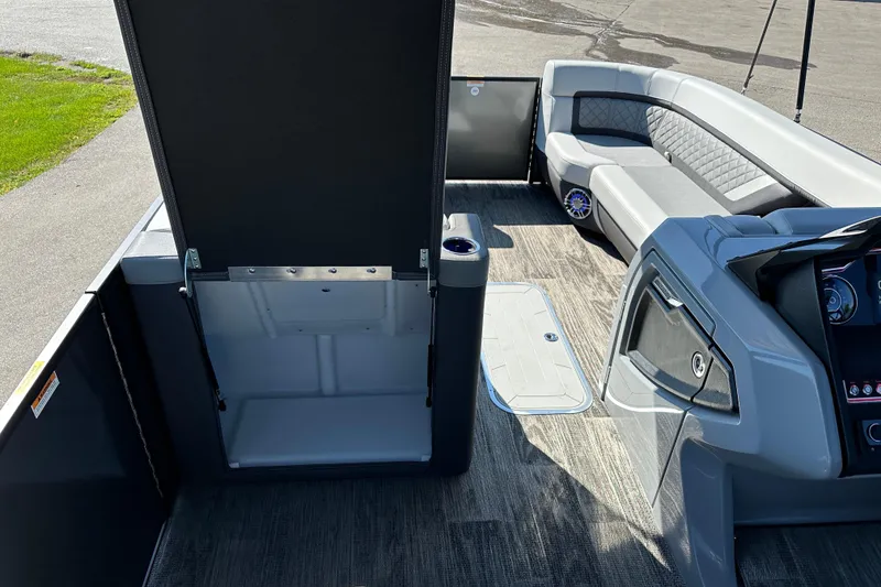 Slide: The Image of Interior of 2025 Godfrey AquaPatio 255 SB pontoon boat with modern seating and dashboard. - 25