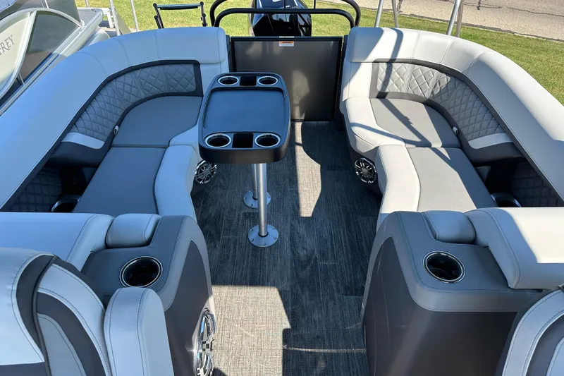 Slide: The Image of Luxurious seating on 2025 Godfrey AquaPatio 255 SB pontoon boat with cup holders and table. - 26