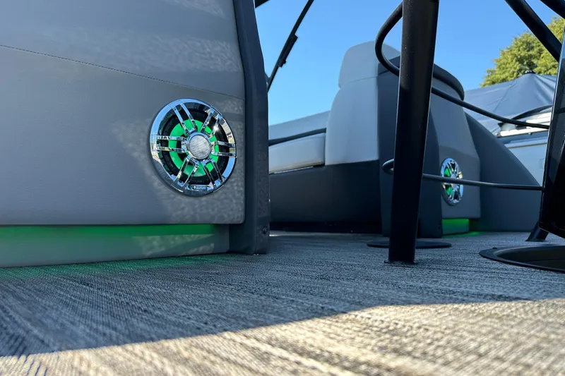 Slide: The Image of 2025 Godfrey AquaPatio 255 SB boat interior with stylish speaker and seating. - 6