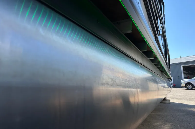 Slide: The Image of Close-up of 2025 Godfrey AquaPatio 255 SB pontoon boat with green LED lights. - 7