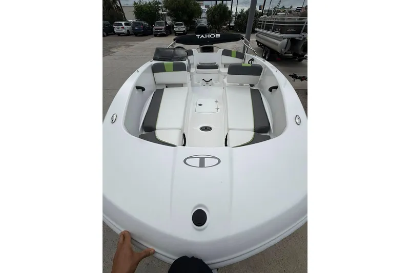 The Image of 2023 Tahoe T18 boat with spacious seating and sleek design, parked outdoors. - 1