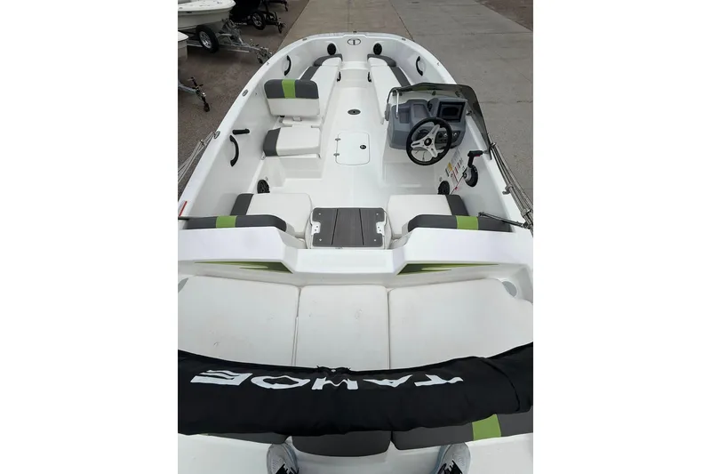 Slide: The Image of 2023 Tahoe T18 boat interior with seating and steering wheel, displayed on a concrete surface. - 5