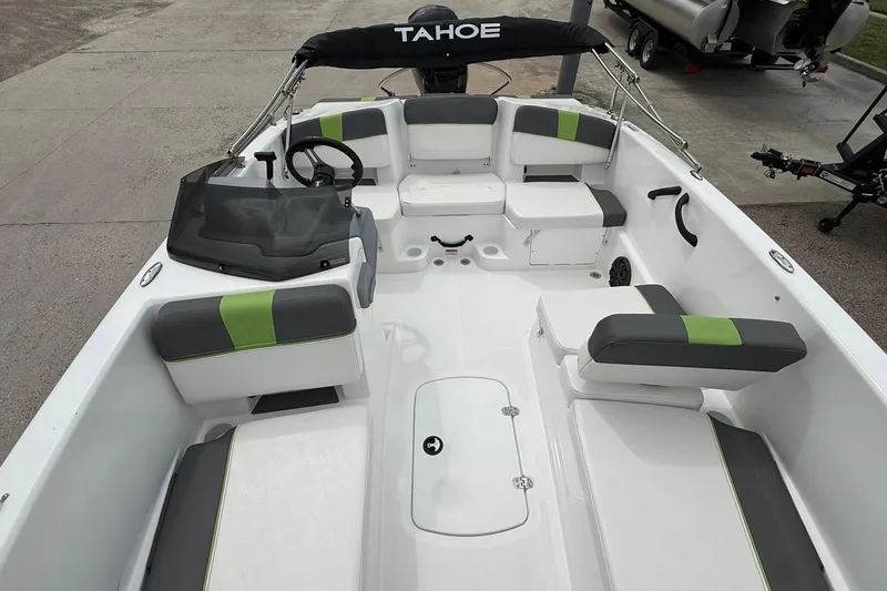 Slide: The Image of 2023 Tahoe T18 boat interior with seating and steering wheel, featuring modern design elements. - 6