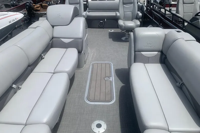 Slide: The Image of Luxurious interior of 2025 Regency 250 DL3 pontoon boat with plush seating. - 2