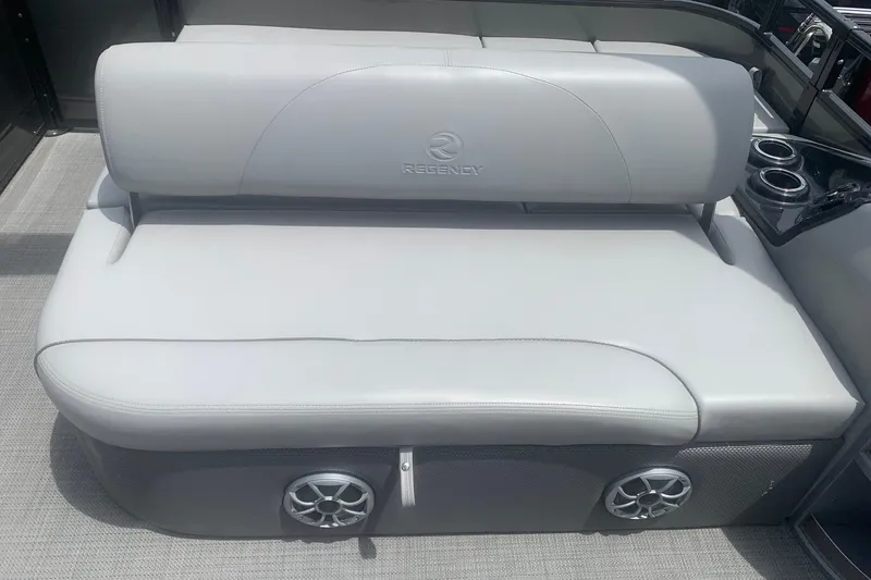 Slide: The Image of Luxurious seating on 2025 Regency 250 DL3 pontoon boat with integrated speakers and cup holders. - 3