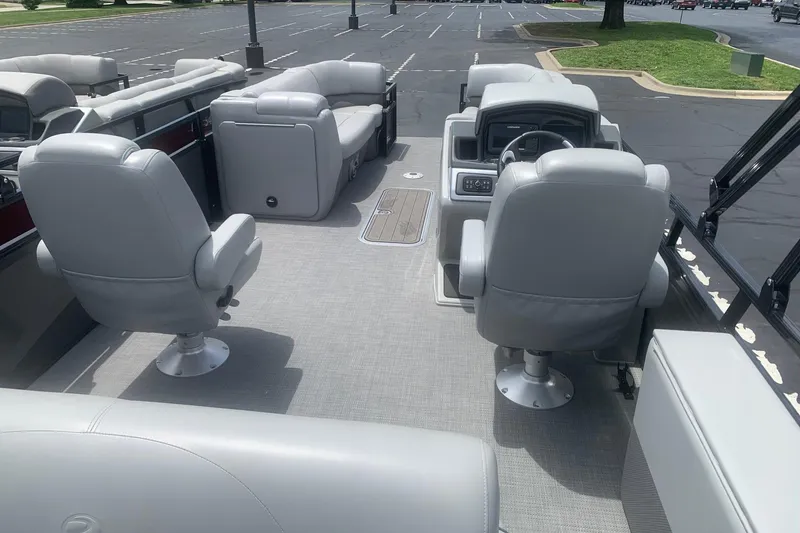 Slide: The Image of 2025 Regency 250 DL3 pontoon boat interior with plush seating and modern dashboard. - 4
