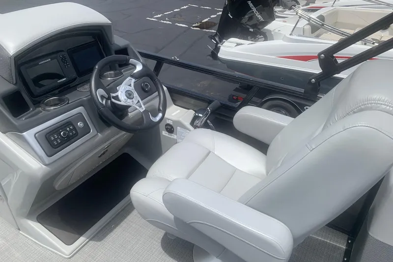 Slide: The Image of Interior of 2025 Regency 250 DL3 boat featuring steering wheel and control panel. - 6