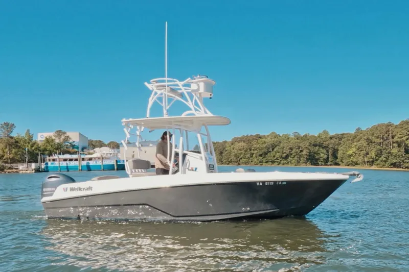 Slide: The Image of 2020 Wellcraft 222 Fisherman boat cruising on a sunny day in a scenic waterway. - 13
