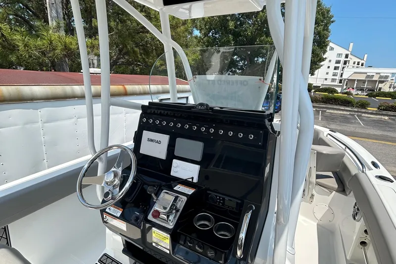 Slide: The Image of 2020 Wellcraft 222 Fisherman boat console with steering wheel and navigation controls. - 4