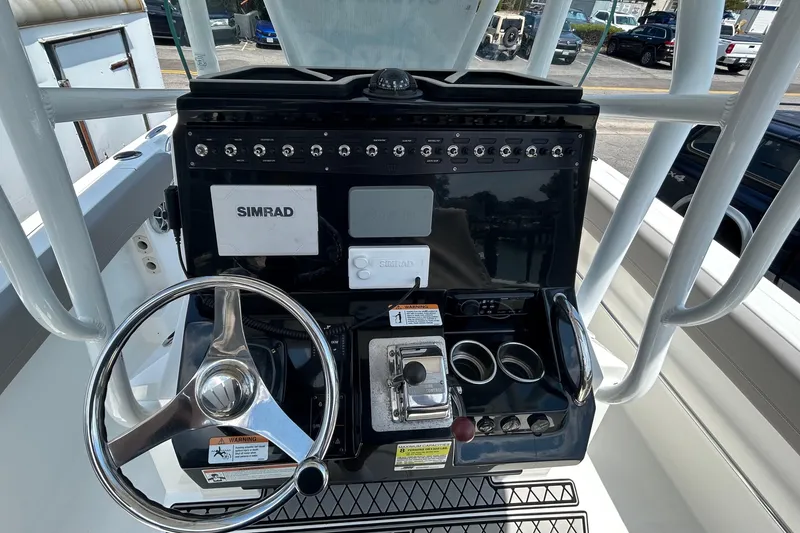 Slide: The Image of Center console of 2020 Wellcraft 222 Fisherman boat with steering wheel and controls. - 5