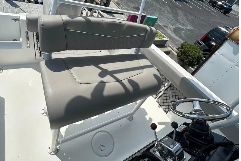 Slide: The Image of 2020 Wellcraft 222 Fisherman boat helm with gray seating and steering wheel. - 6
