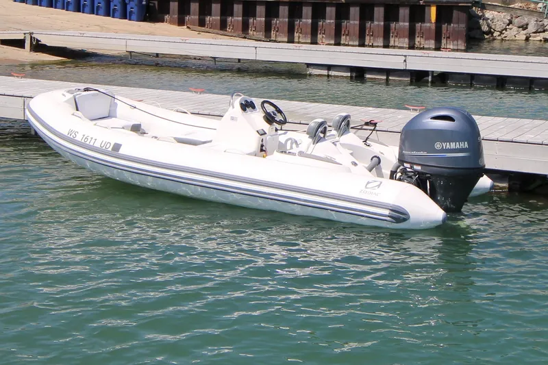 The Image of 2023 Zodiac Yachtline 490 boat docked with Yamaha outboard motor. - 1