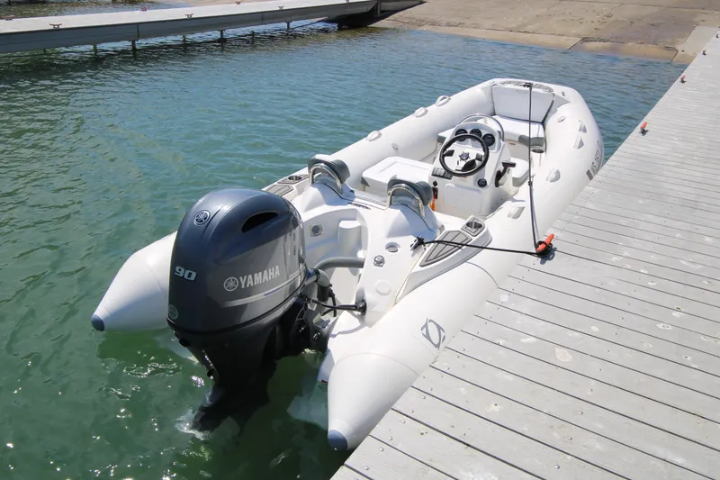 Slide: The Image of 2023 Zodiac Yachtline 490 inflatable boat docked with Yamaha outboard motor. - 3