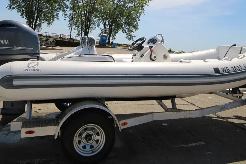 Slide: The Image of 2023 Zodiac Yachtline 490 inflatable boat on trailer, featuring Yamaha engine. - 8
