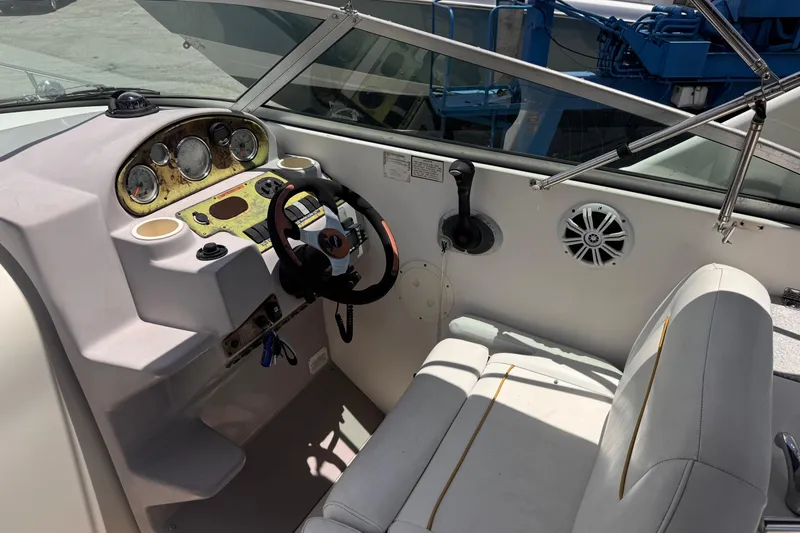 Slide: The Image of 2004 Rinker Fiesta Vee 270 boat cockpit with steering wheel and dashboard controls. - 10