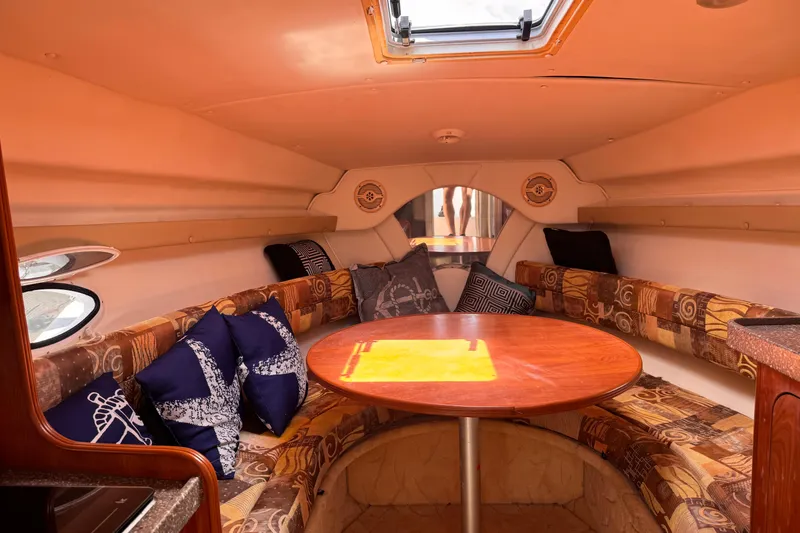 Slide: The Image of Interior of 2004 Rinker Fiesta Vee 270 boat with cozy seating and table. - 11