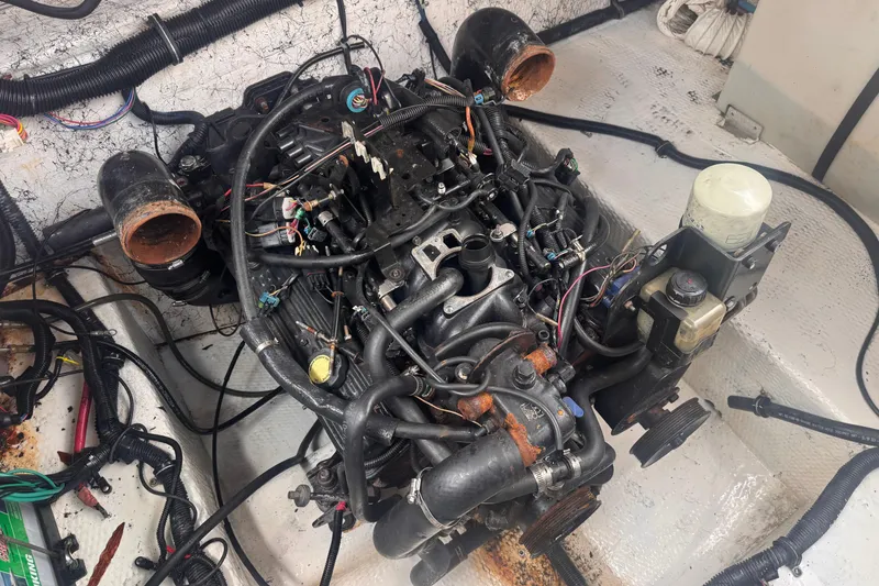 Slide: The Image of Engine compartment of a 2004 Rinker Fiesta Vee 270 boat, showing detailed wiring and components. - 18