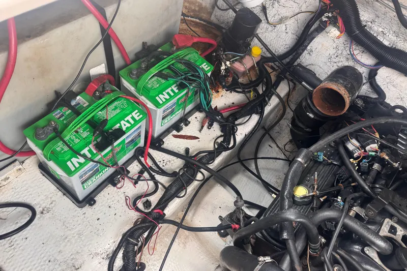 Slide: The Image of 2004 Rinker Fiesta Vee 270 engine compartment with Interstate batteries and wiring. - 19