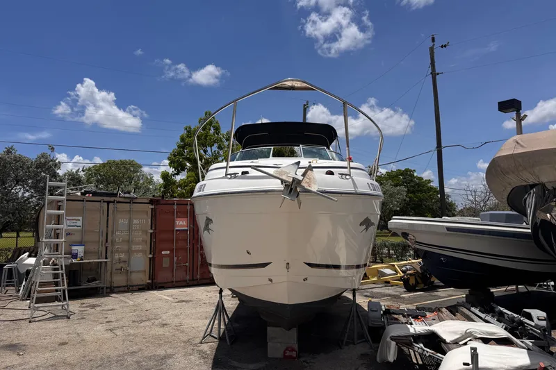 Slide: The Image of 2004 Rinker Fiesta Vee 270 boat on dry dock under clear blue sky. - 2