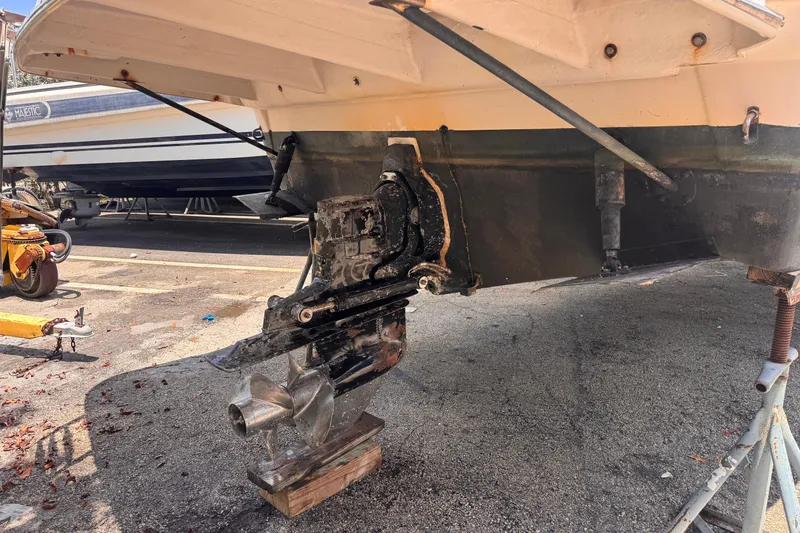 Slide: The Image of 2004 Rinker Fiesta Vee 270 boat outdrive on dry dock for maintenance. - 4