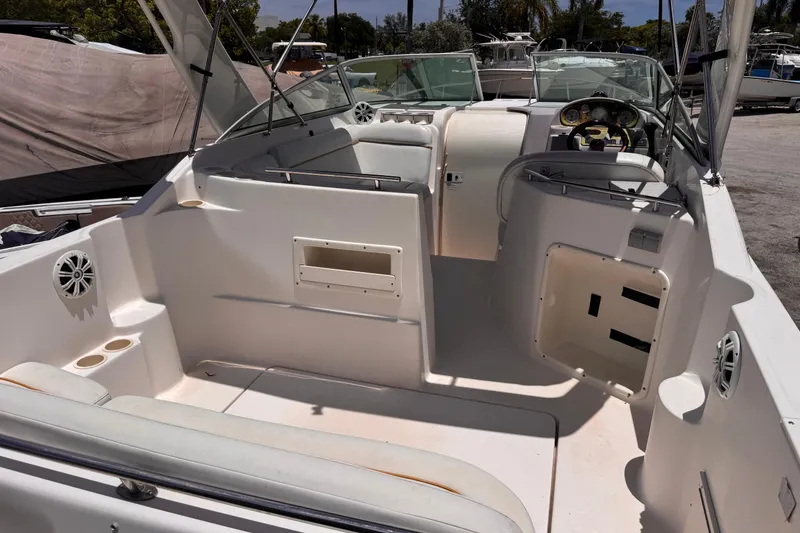 Slide: The Image of 2004 Rinker Fiesta Vee 270 boat interior with seating and steering console. - 7