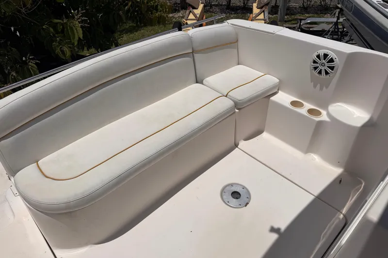 Slide: The Image of 2004 Rinker Fiesta Vee 270 boat interior with white seating and cup holders. - 8