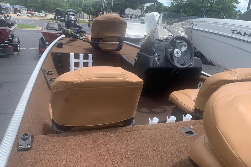 Slide: The Image of 2018 Tracker Bass Tracker 40th Anniversary Heritage Edition boat interior with tan seats and steering console. - 3