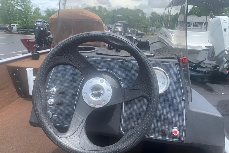 Slide: The Image of 2018 Tracker Bass Tracker 40th Anniversary Heritage Edition boat dashboard with steering wheel. - 6