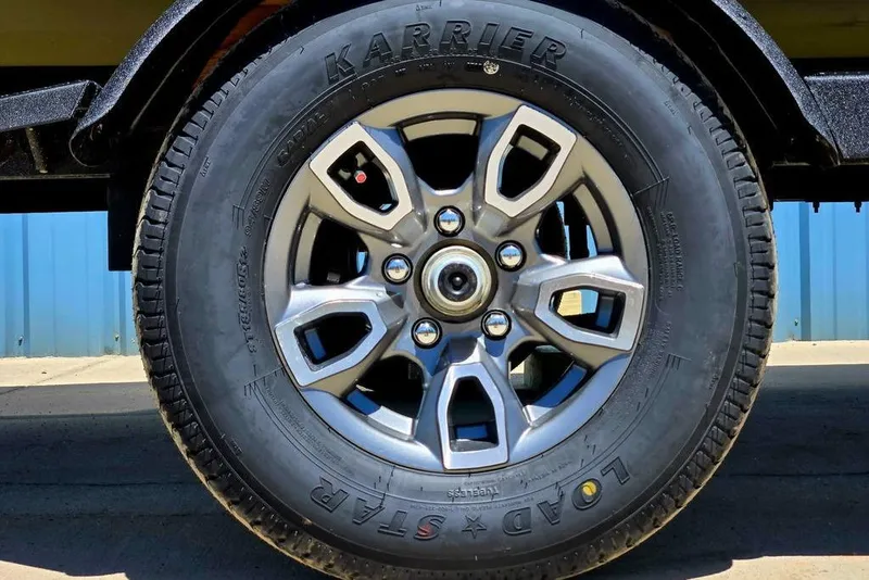 Slide: The Image of 2026 Tracker Pro Team 190 wheel with Karrier Load Star tire on pavement. - 11