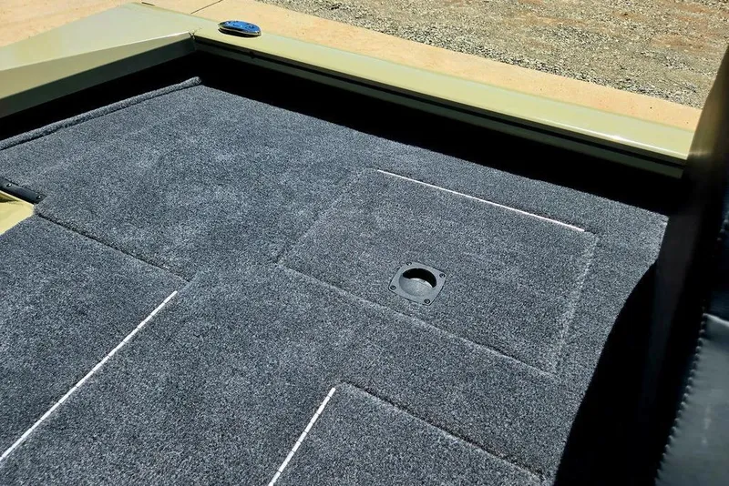 Slide: The Image of 2026 Tracker Pro Team 190 boat deck with gray carpet and storage compartment. - 29