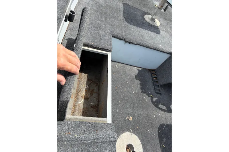 Slide: The Image of 1995 Tracker Pro Deep V-17 boat interior with open storage compartment. - 10