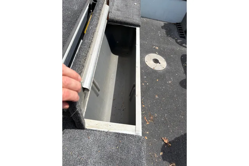 Slide: The Image of Open storage compartment on 1995 Tracker Pro Deep V-17 boat deck. - 11