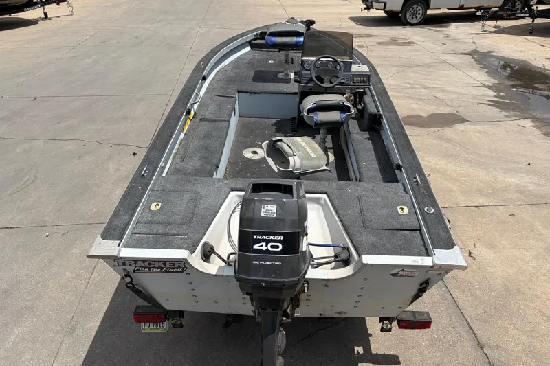 Slide: The Image of 1995 Tracker Pro Deep V-17 boat with Tracker 40 outboard motor, parked on concrete. - 2