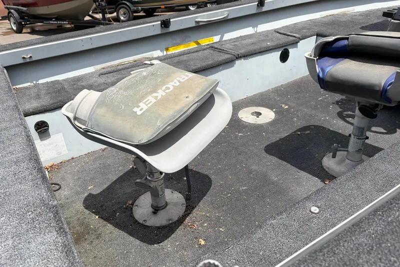 Slide: The Image of 1995 Tracker Pro Deep V-17 boat interior with swivel seats and carpeted flooring. - 7