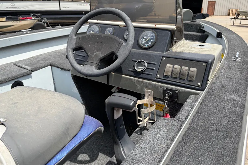 Slide: The Image of 1995 Tracker Pro Deep V-17 boat interior with steering wheel and control panel. - 8