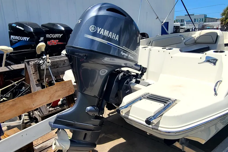 Slide: The Image of 2023 Stingray 182 SC boat with Yamaha outboard motor, docked outdoors. - 15